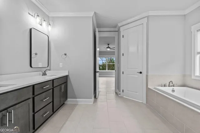 a spacious bathroom with a double vanity sink mirror and double