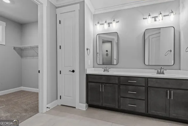 a bathroom with double vanity sinks and a mirror