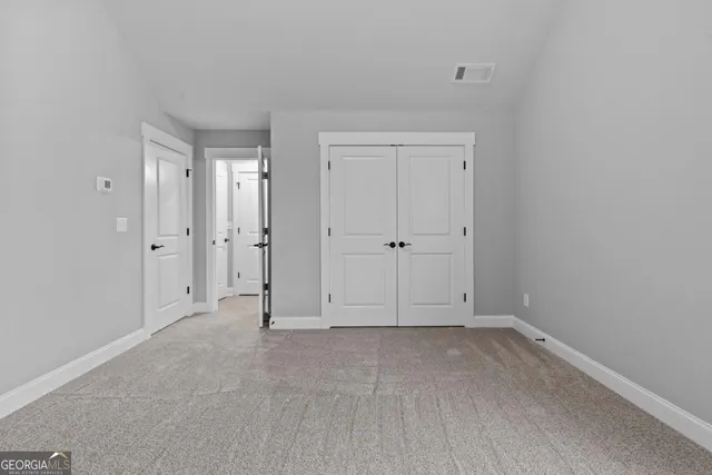 a view of an empty room and a window