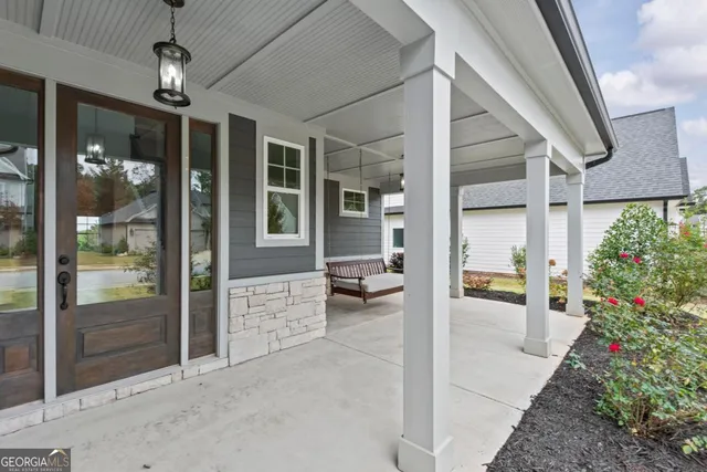 a view of a house next to a big yard with large trees