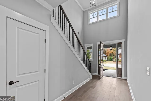 a view of a hallway with wooden floor and entryway