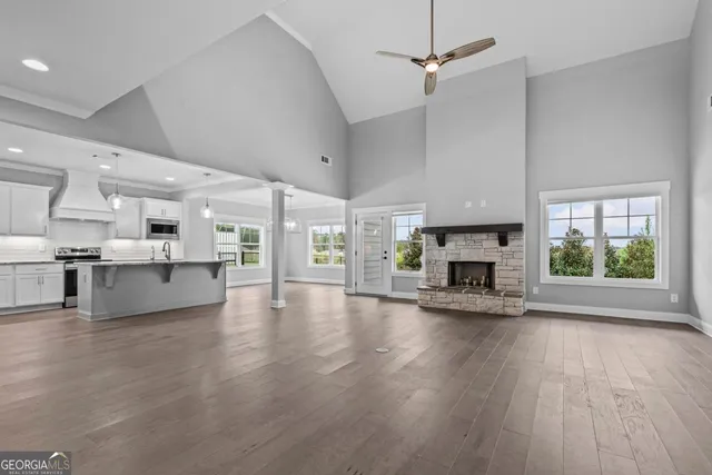a view of a living room a fireplace and windows