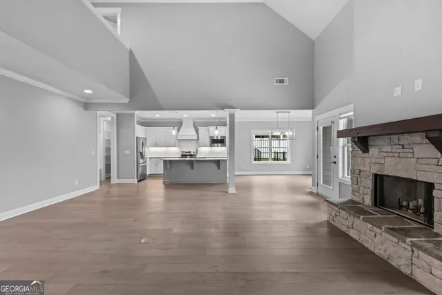 a view of an empty room with a fireplace