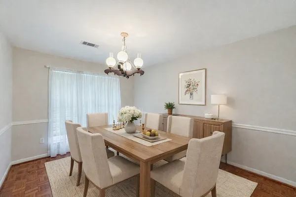 a view of a dining room with furniture and chandelier