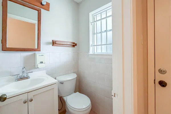 a bathroom with a toilet a sink and a window