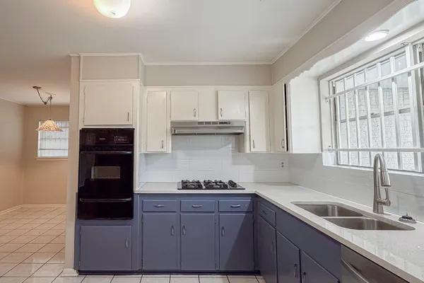 a kitchen with granite countertop a refrigerator and a sink
