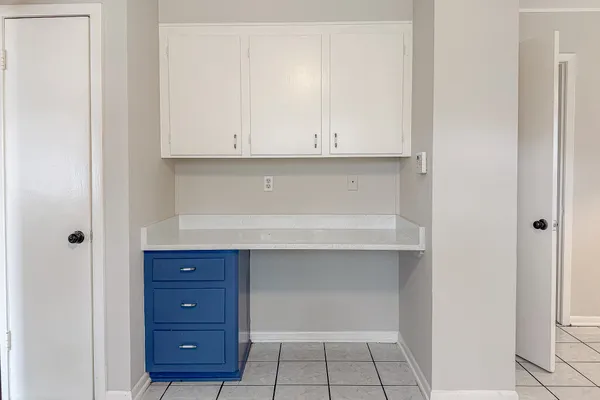 a view of an empty room and cabinets