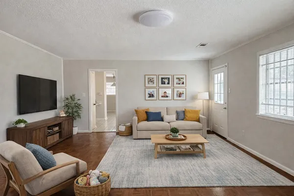 a living room with furniture and a flat screen tv