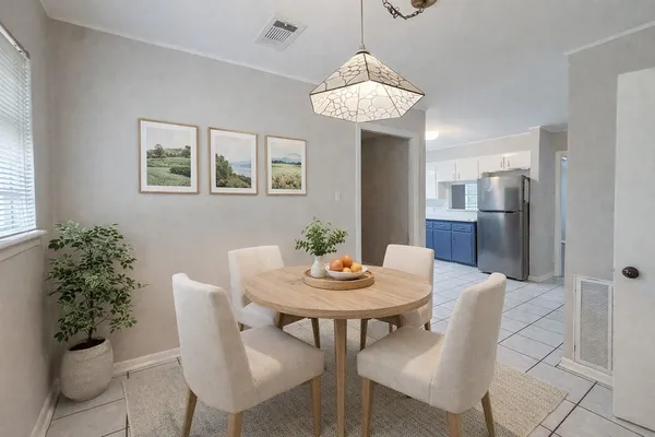 a view of a dining room with furniture and chandelier