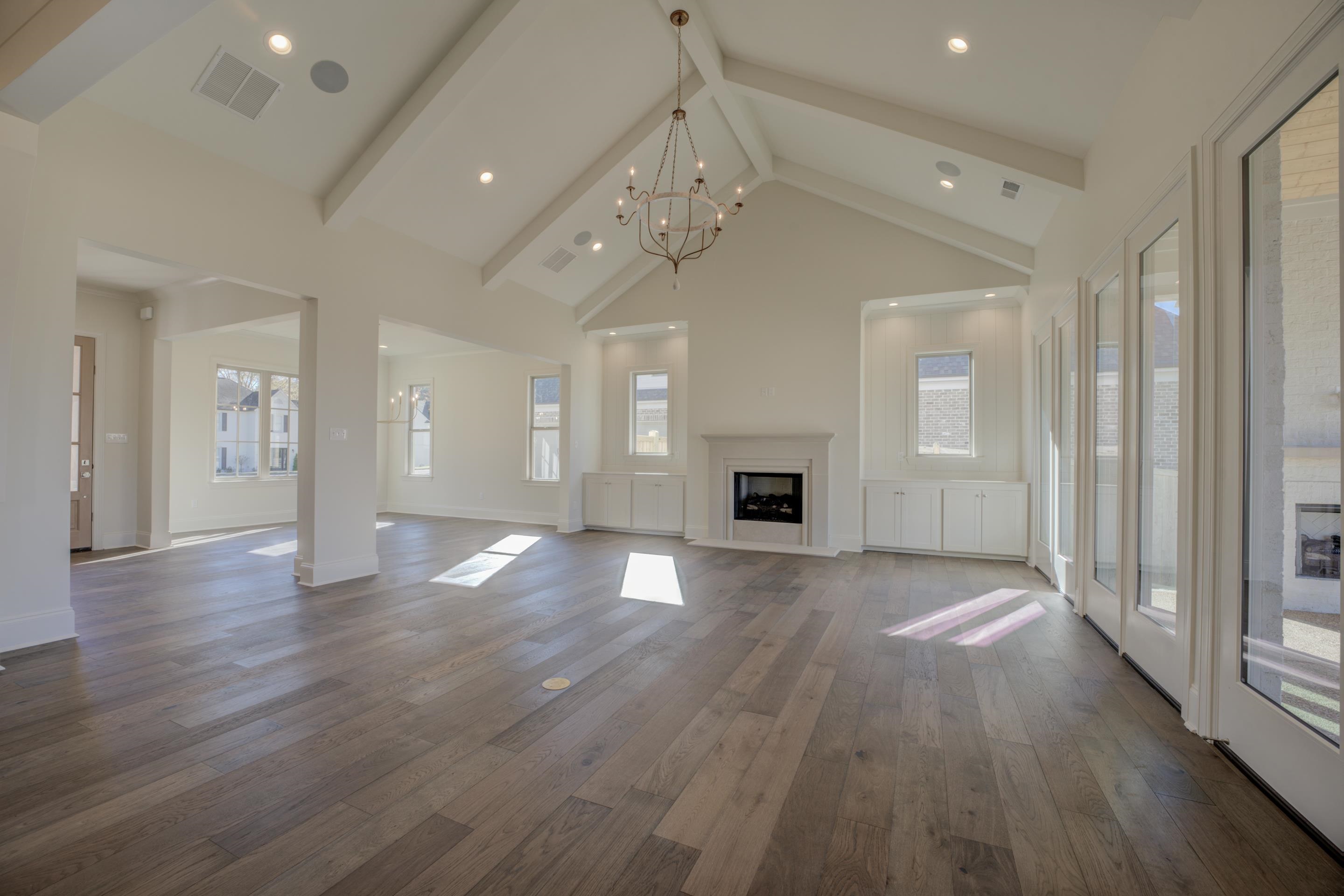 3329 Bailey Station Road Collierville, TN 38017 - Photo 12 of 31 Unfurnished living room featuring high vaulted ceiling, dark wood-type flooring, and a wealth of natural light