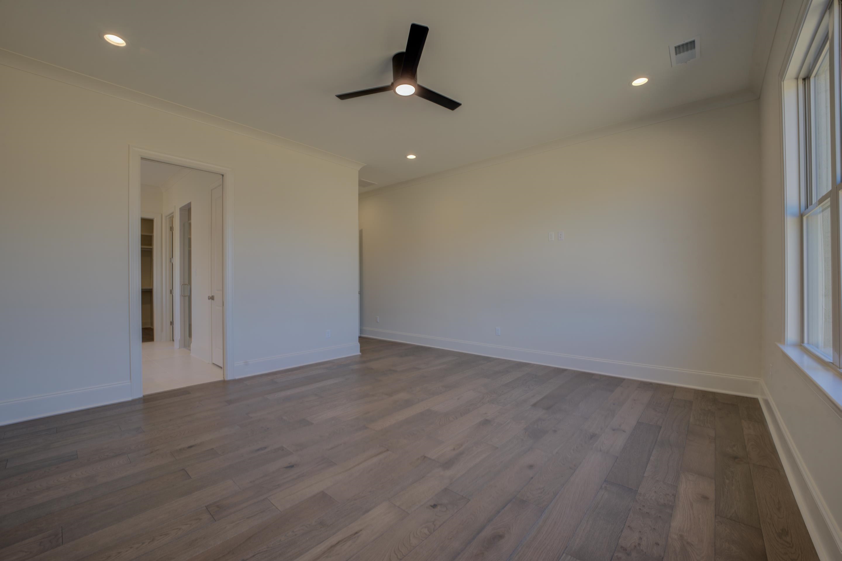 3329 Bailey Station Road Collierville, TN 38017 - Photo 13 of 31 Empty room with hardwood / wood-style floors, ceiling fan, and ornamental molding