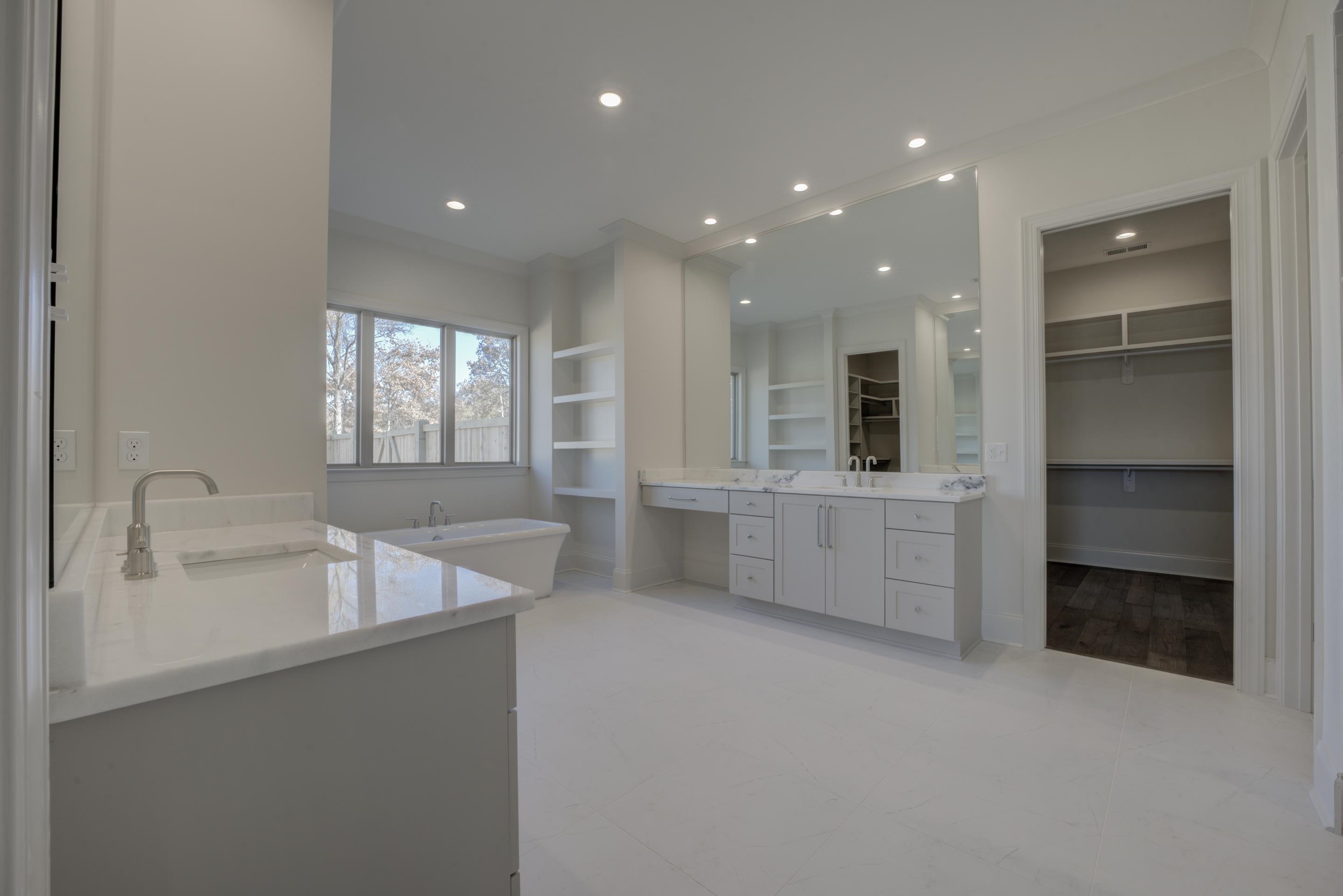 3329 Bailey Station Road Collierville, TN 38017 - Photo 14 of 31 Bathroom featuring crown molding, a bathtub, vanity, and built in features