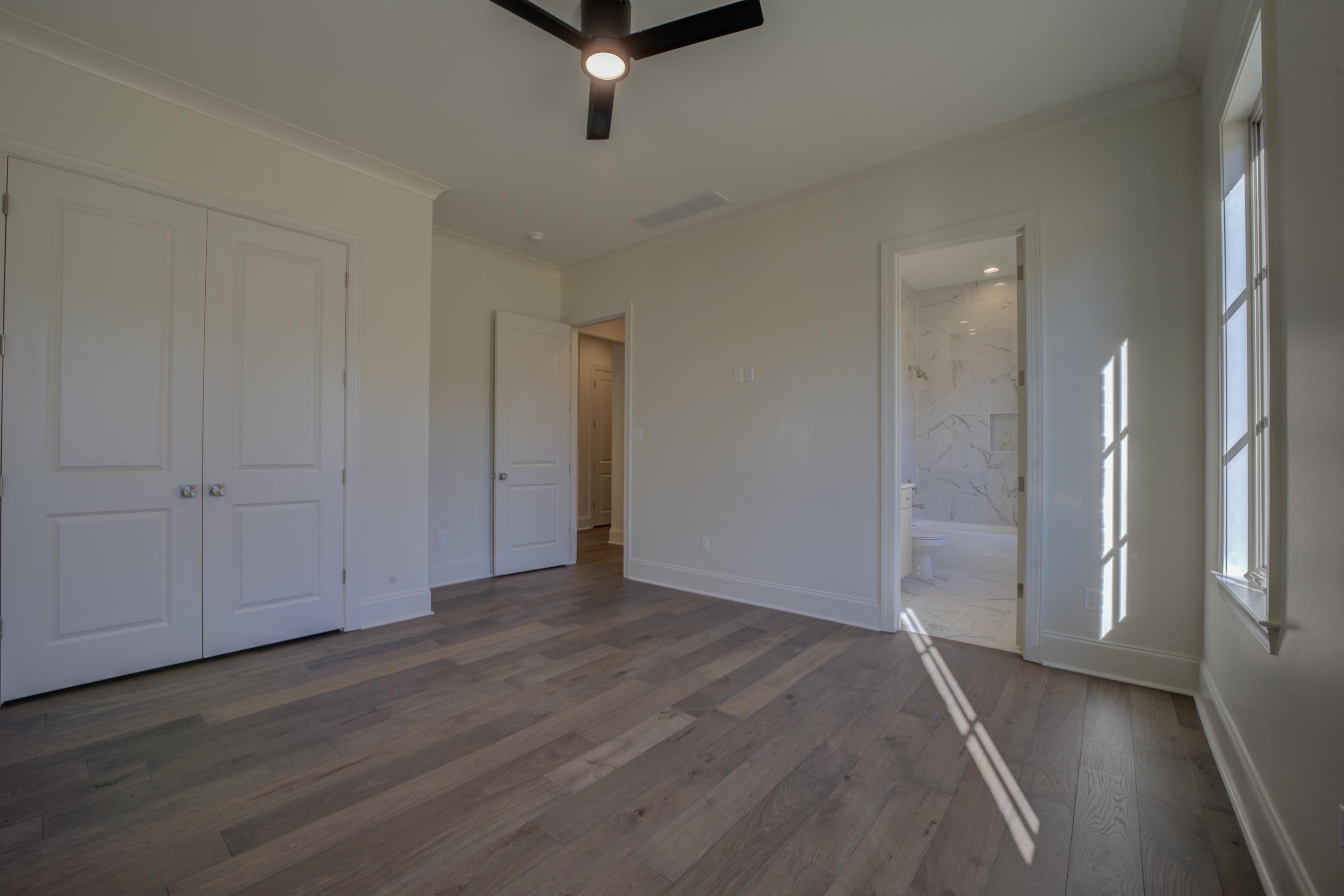 3329 Bailey Station Road Collierville, TN 38017 - Photo 20 of 31 Unfurnished bedroom featuring ensuite bath, ceiling fan, dark hardwood / wood-style floors, and ornamental molding