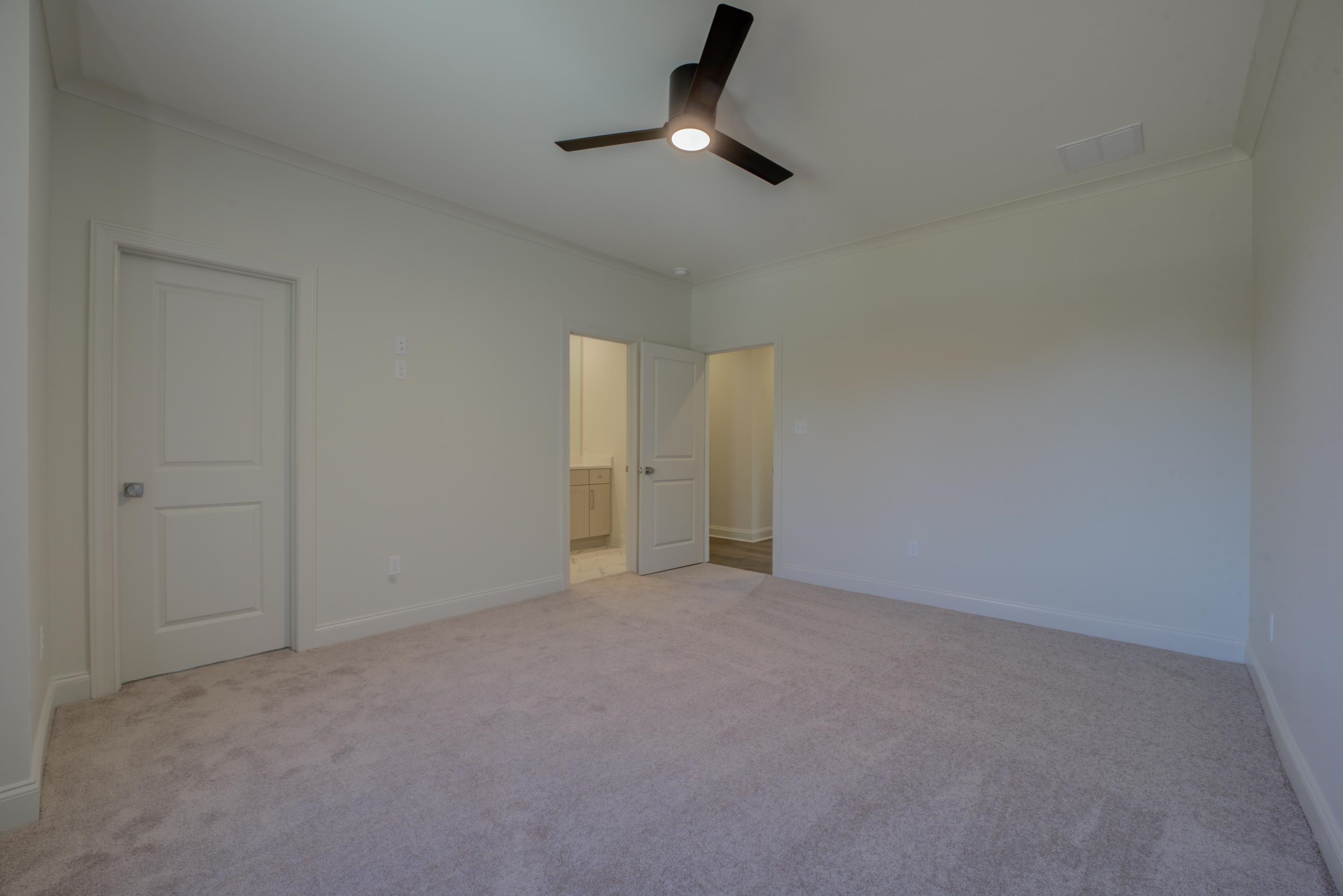 3329 Bailey Station Road Collierville, TN 38017 - Photo 25 of 31 Unfurnished bedroom with ceiling fan, light colored carpet, and ornamental molding