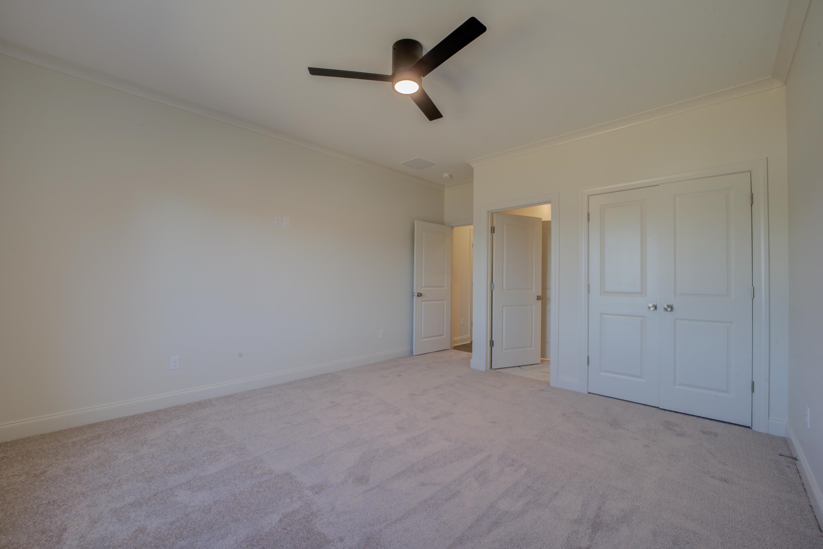 3329 Bailey Station Road Collierville, TN 38017 - Photo 26 of 31 Unfurnished bedroom featuring ceiling fan, light carpet, and ornamental molding