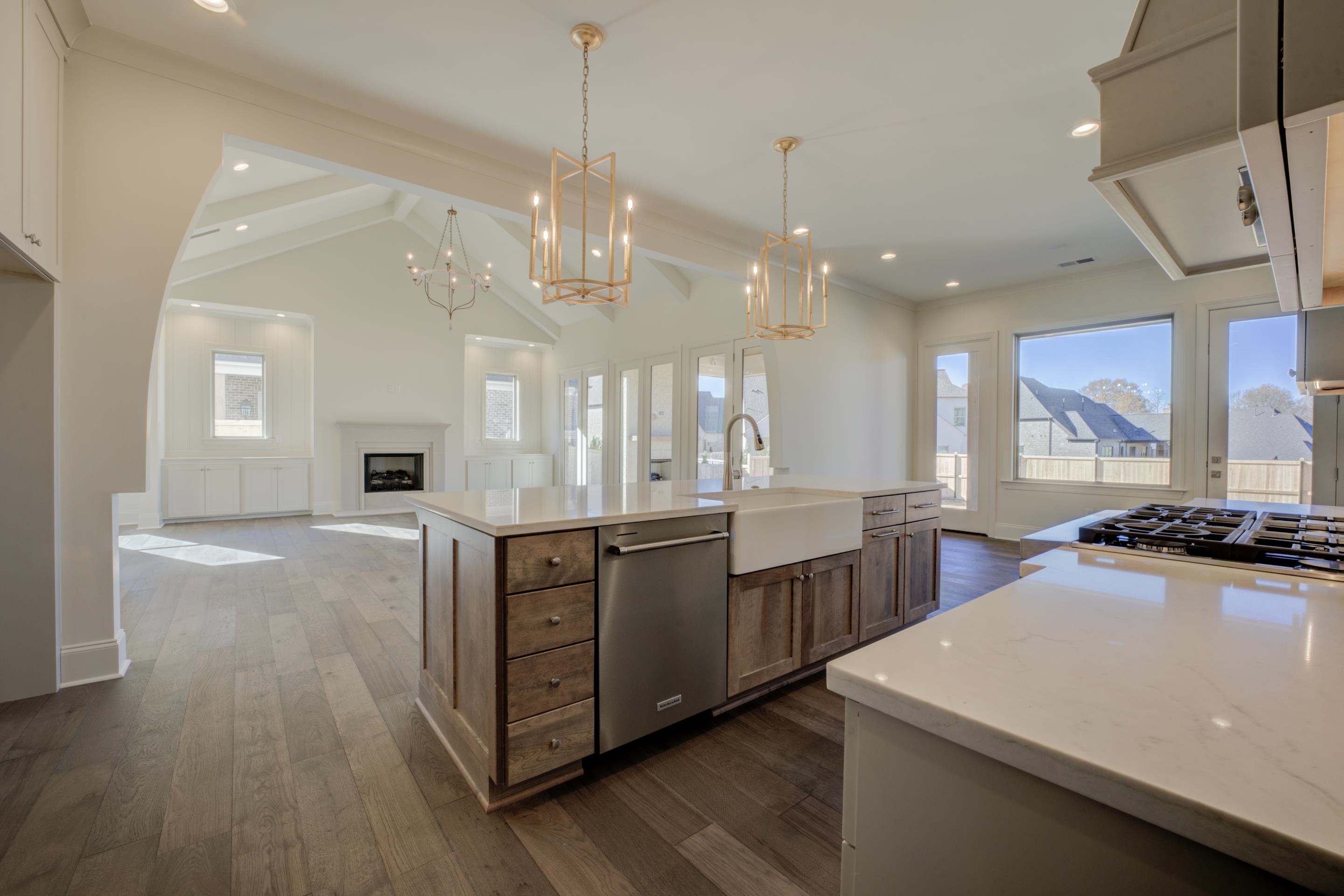 3329 Bailey Station Road Collierville, TN 38017 - Photo 5 of 31 Kitchen with vaulted ceiling with beams, designer light fixtures, stainless steel appliances, and dark hardwood floors. Beautiful Soft Maple cabinets on island.