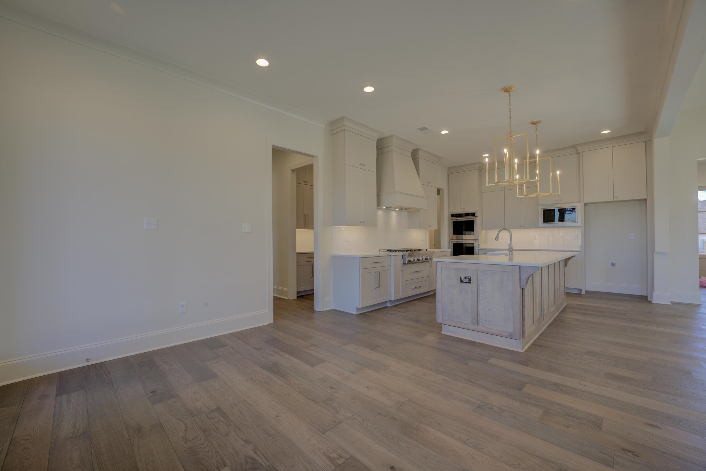 3329 Bailey Station Road Collierville, TN 38017 - Photo 7 of 31 Kitchen with premium range hood, designer light fixtures, island with sink