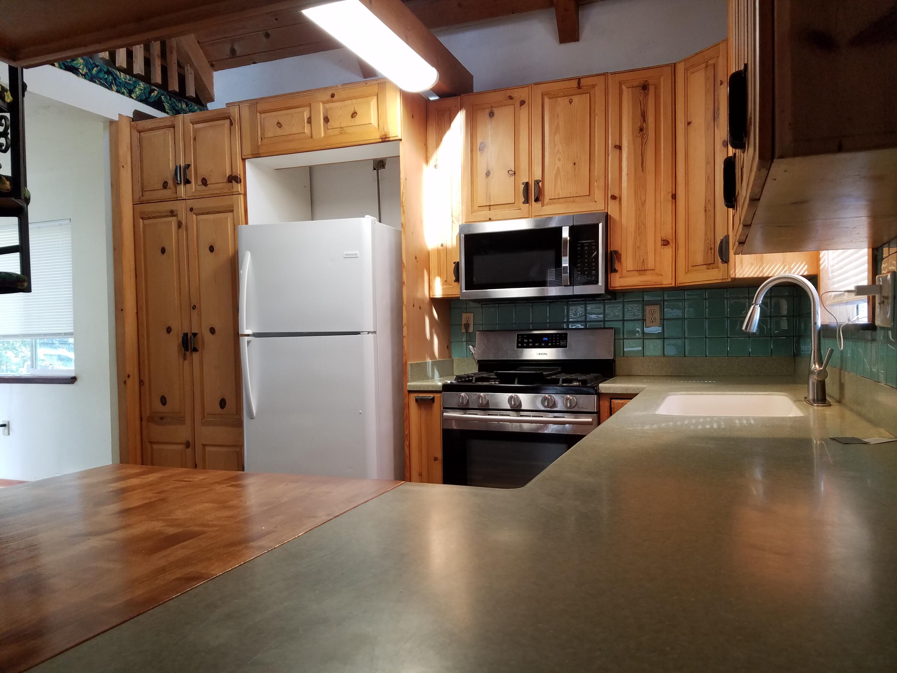 6200 Wilson Hill Road Shingletown, CA 96088 - Photo 22 of 45 a kitchen with a refrigerator and a stove top oven