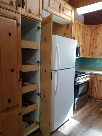 a kitchen with a refrigerator and a stove