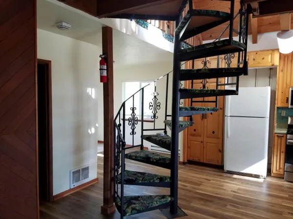 a view of entryway and hall with wooden floor