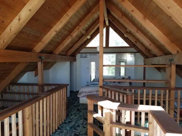 a view of a patio with table and chairs with wooden fence and plants