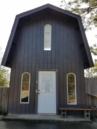 a view of swimming pool with a yard and trees