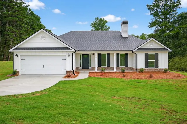 a front view of a house with a yard and porch