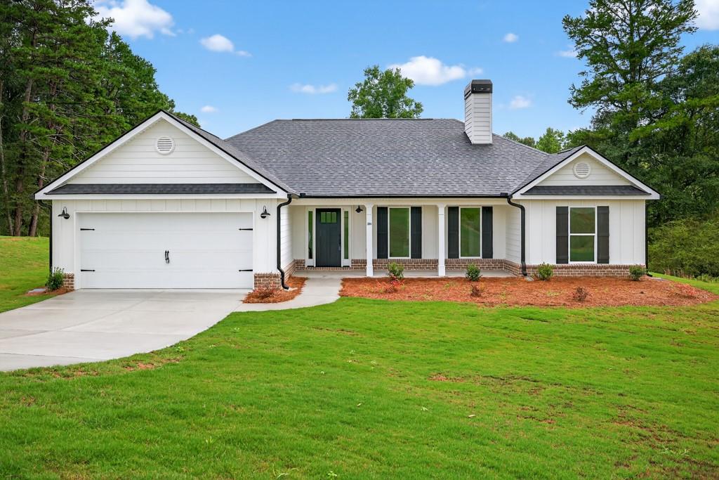 a front view of a house with a yard and porch