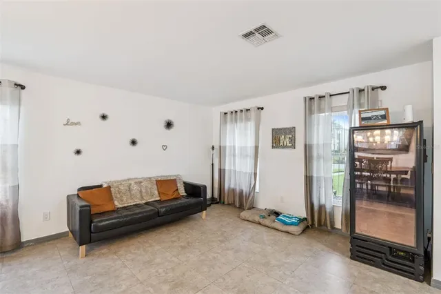 a living room with furniture and a walk in closet