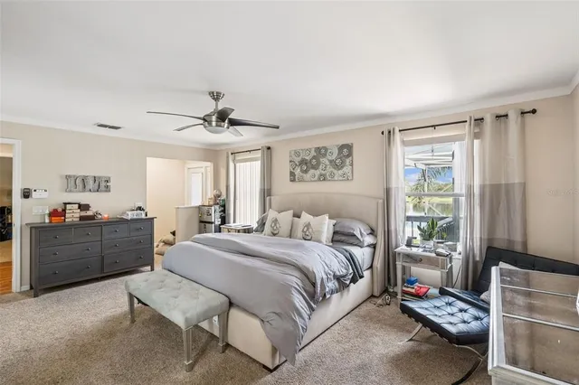 a spacious bedroom with a bed and a window