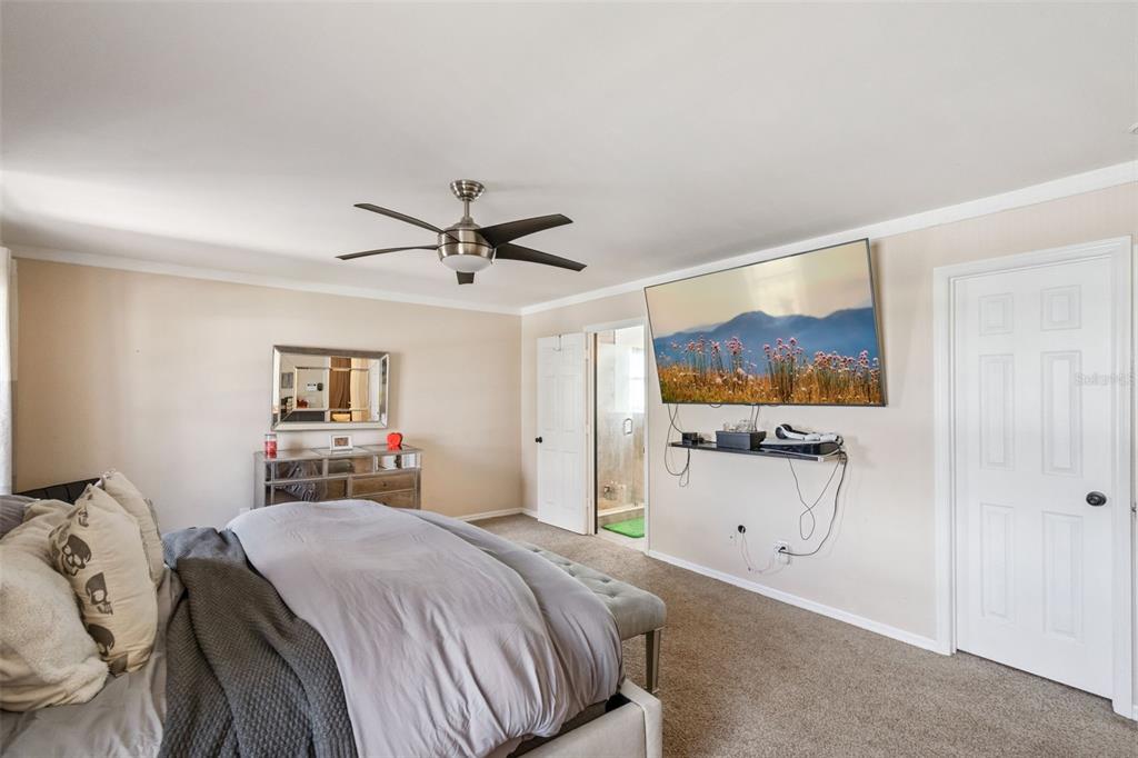 1411 Clarks Summit Court Orlando, FL 32828 - Photo 14 of 50 a bedroom with a bed and a flat screen tv