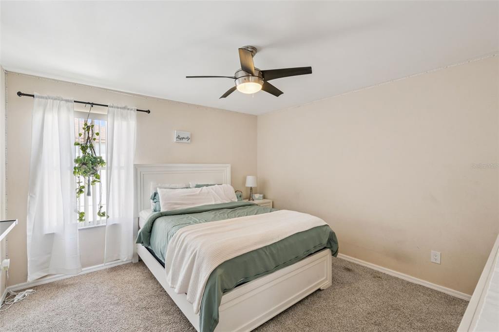 1411 Clarks Summit Court Orlando, FL 32828 - Photo 15 of 50 a bedroom with a bed and a window