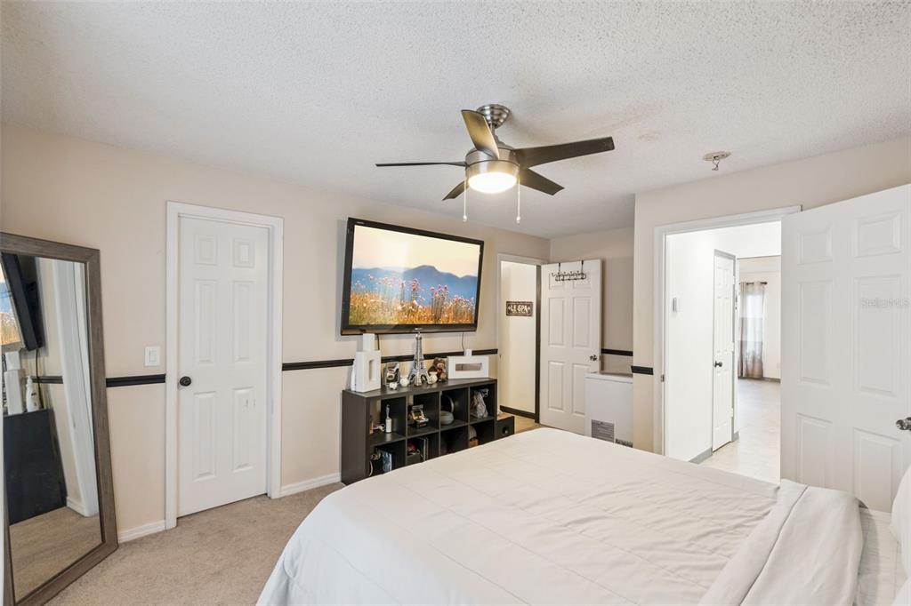 1411 Clarks Summit Court Orlando, FL 32828 - Photo 17 of 50 a bedroom with a bed and a flat screen tv