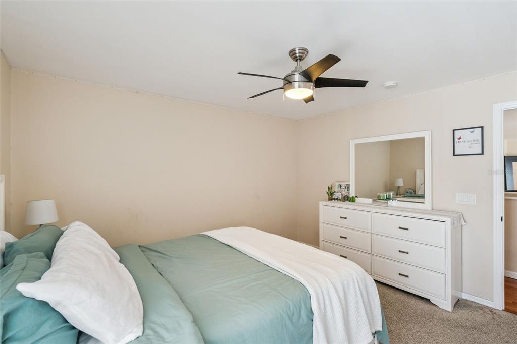1411 Clarks Summit Court Orlando, FL 32828 - Photo 18 of 50 a bedroom with a bed and a chandelier