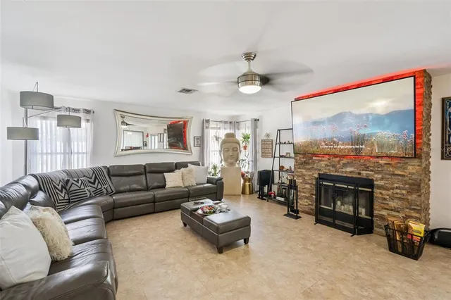 a living room with furniture flat screen tv and a fireplace
