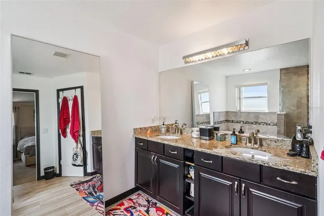 a view of a double sink and a mirror