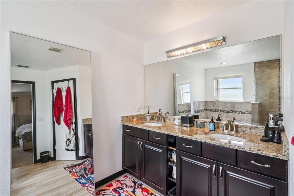 1411 Clarks Summit Court Orlando, FL 32828 - Photo 22 of 50 a view of a double sink and a mirror