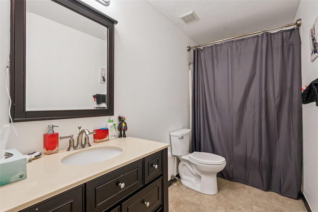 1411 Clarks Summit Court Orlando, FL 32828 - Photo 23 of 50 a bathroom with a sink vanity mirror and toilet