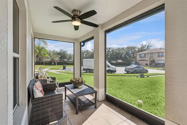 a living room with garden area and a floor to ceiling window