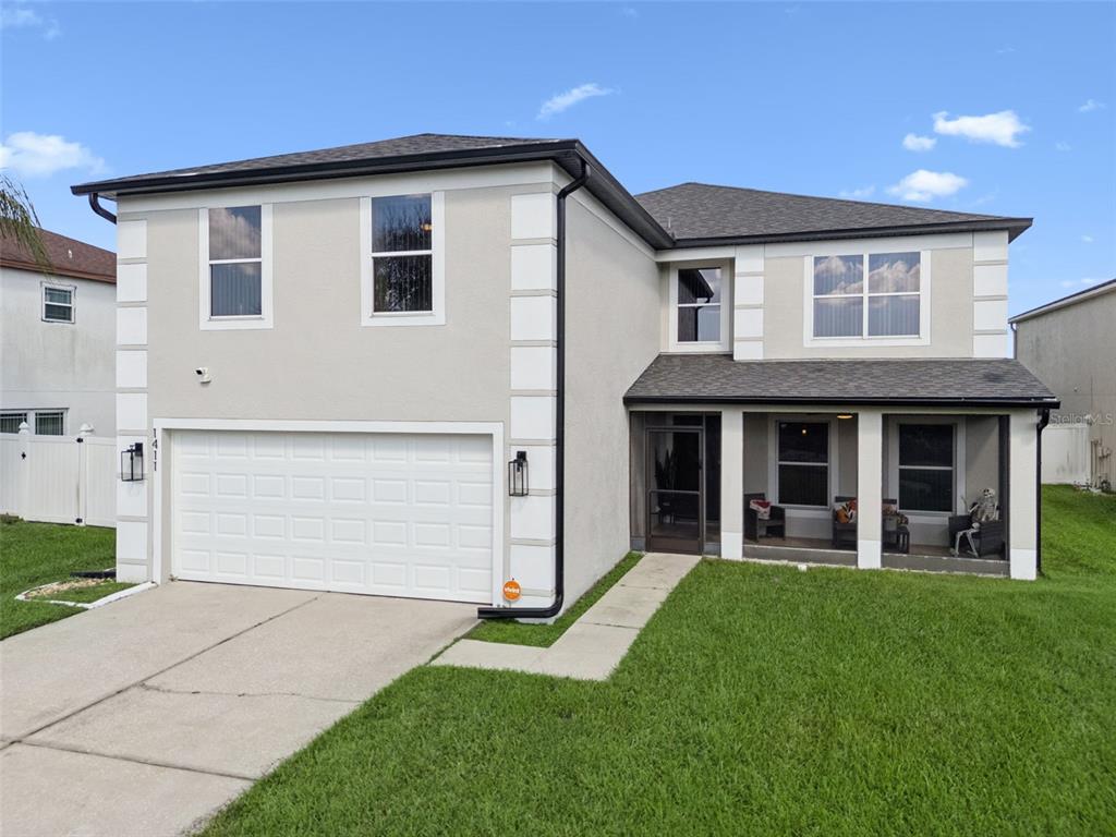 1411 Clarks Summit Court Orlando, FL 32828 - Photo 40 of 50 a front view of a house with a yard and garage