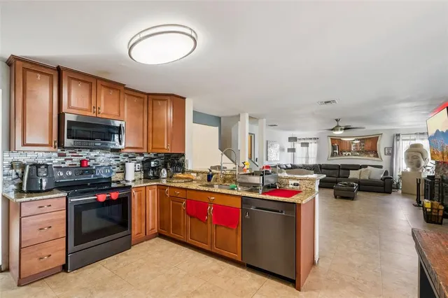 a kitchen with sink a stove and cabinets