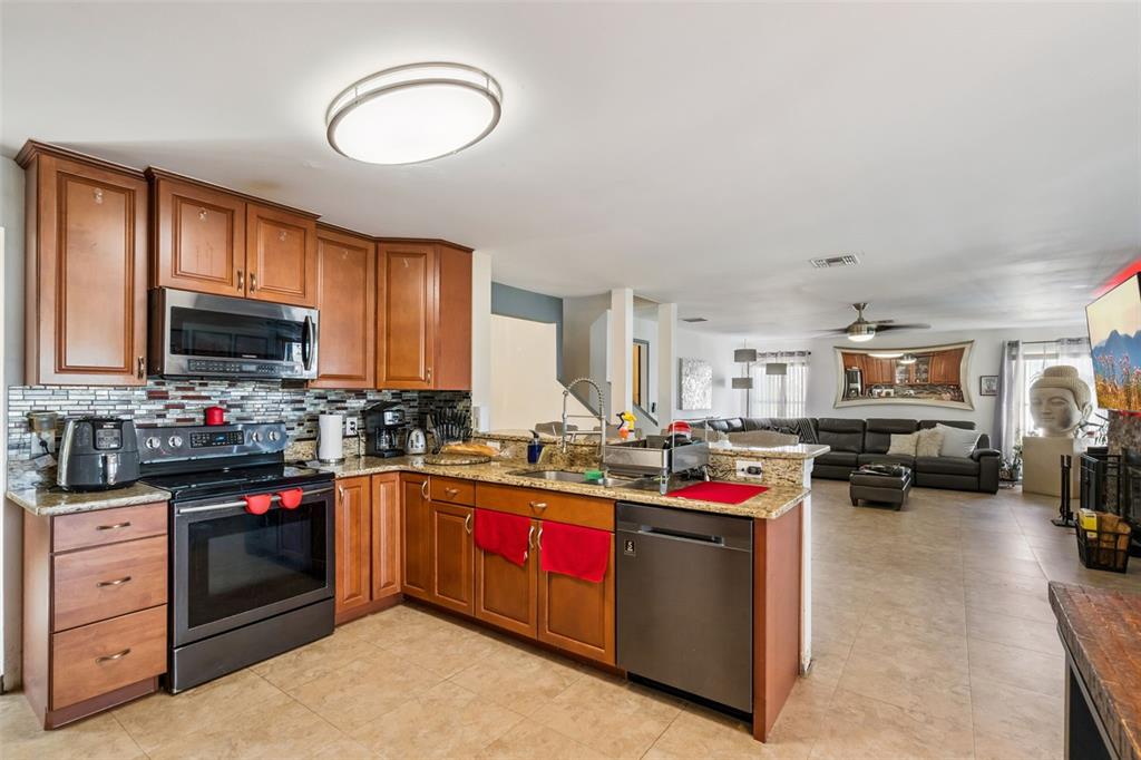 1411 Clarks Summit Court Orlando, FL 32828 - Photo 7 of 50 a kitchen with sink a stove and cabinets