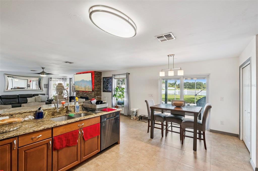 1411 Clarks Summit Court Orlando, FL 32828 - Photo 8 of 50 a kitchen with stainless steel appliances granite countertop a sink and cabinets