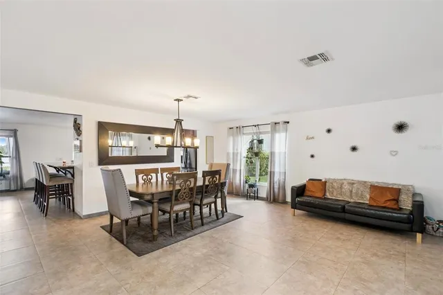 a living room with furniture and a dining table