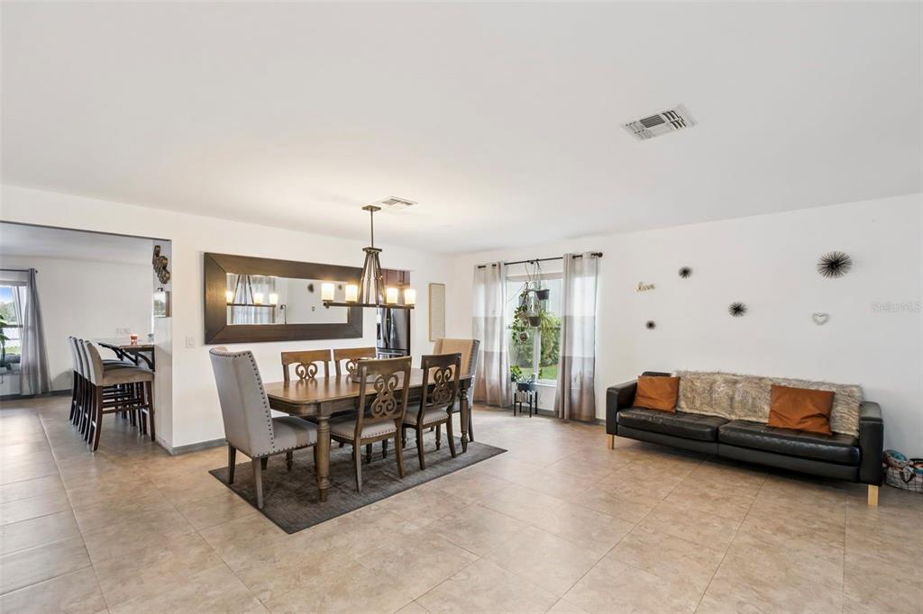 1411 Clarks Summit Court Orlando, FL 32828 - Photo 10 of 50 a living room with furniture and a dining table