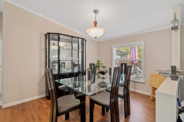 a living room with furniture a flat screen tv and a large window