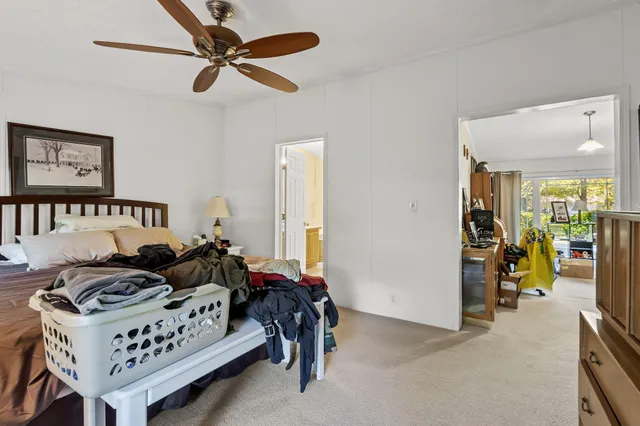 a bedroom with a bed window and flat screen tv