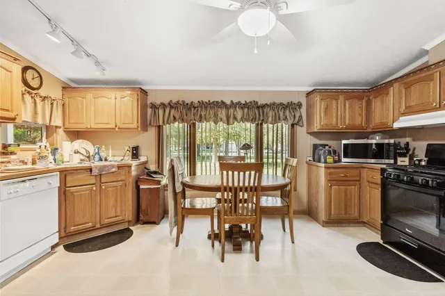 a kitchen with stainless steel appliances granite countertop a refrigerator and a stove top oven