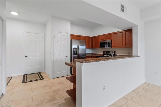 a kitchen with a refrigerator a stove and a sink