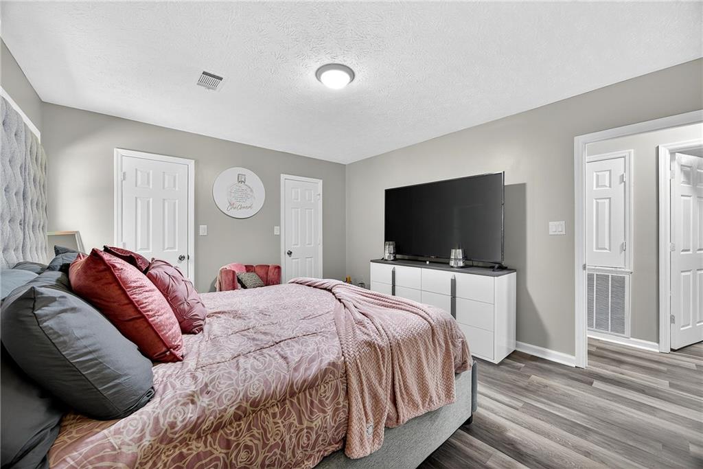 146 Highview Road Southeast Milledgeville, GA 31061 - Photo 12 of 30 a bedroom with a bed and a flat screen tv